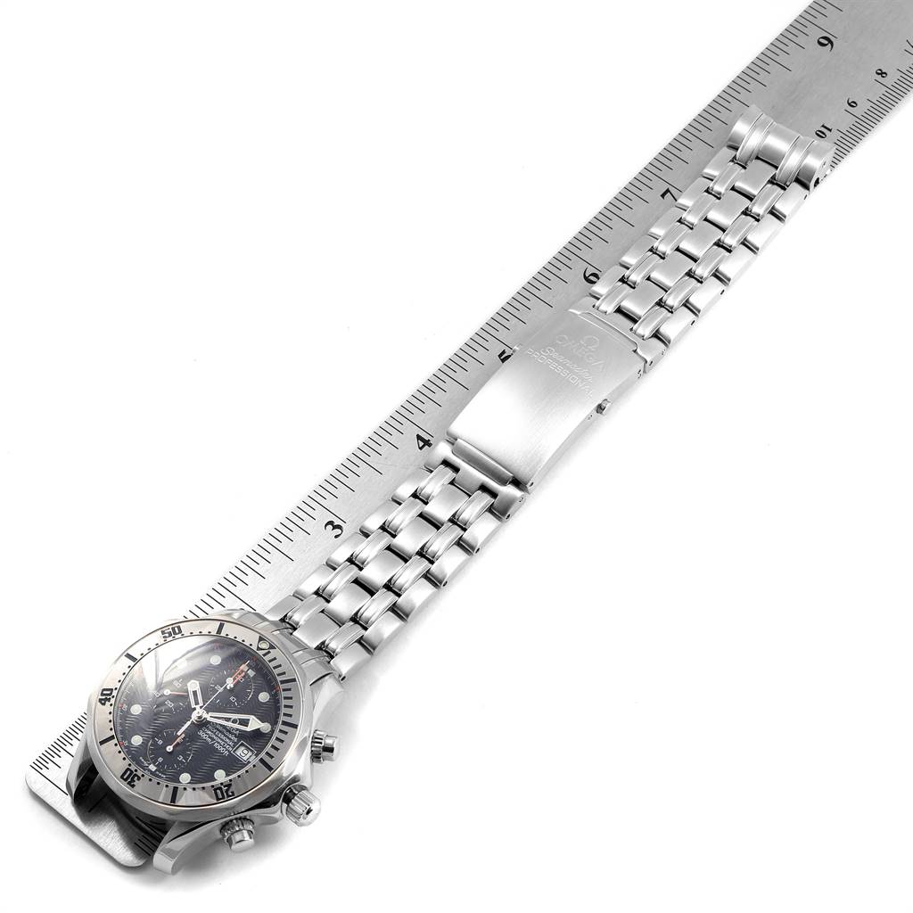 The image shows an Omega Seamaster 2598.80.00 Men
s Stainless Steel Blue Dial 2598.80.00 Men
s Stainless Steel Blue Dial watch from a top-down angle, highlighting its dial, bezel, and metal bracelet measured against a ruler.