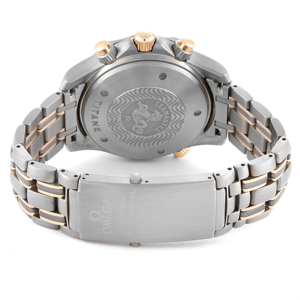 The image shows the back case, crown, and clasp of an Omega Seamaster 2296.80.00 Men
s Titanium Blue Dial 2296.80.00 Men
s Titanium Blue Dial watch, highlighting the titanium and gold accents.