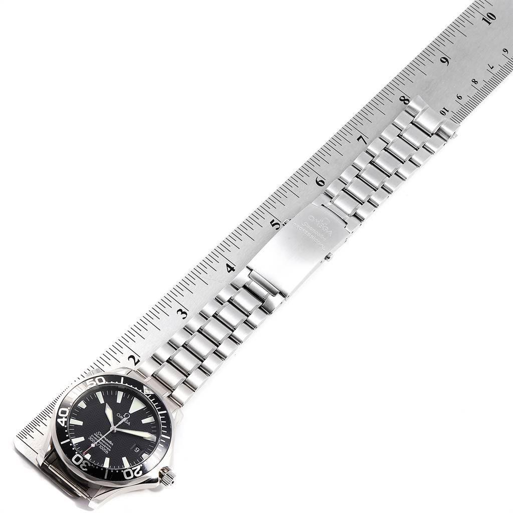 The image shows an Omega Seamaster 2254.50.00 Men
s Stainless Steel Black Dial 2254.50.00 Men
s Stainless Steel Black Dial watch laid flat next to a ruler, displaying its face, bezel, and metallic bracelet.