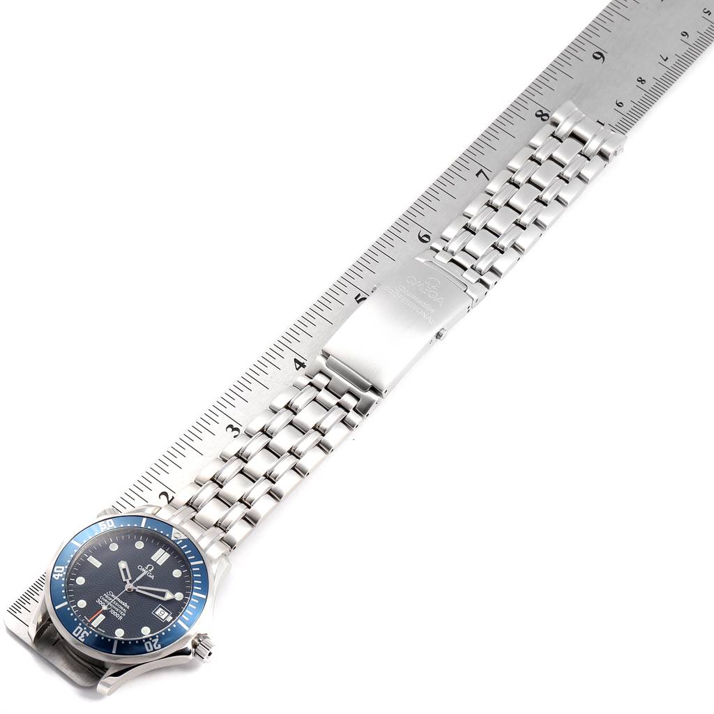 This image shows an Omega Seamaster 2531.80.00 Men
s Stainless Steel Blue Dial 2531.80.00 Men
s Stainless Steel Blue Dial watch laid flat with a ruler next to it, showcasing the dial, bezel, band, and clasp.