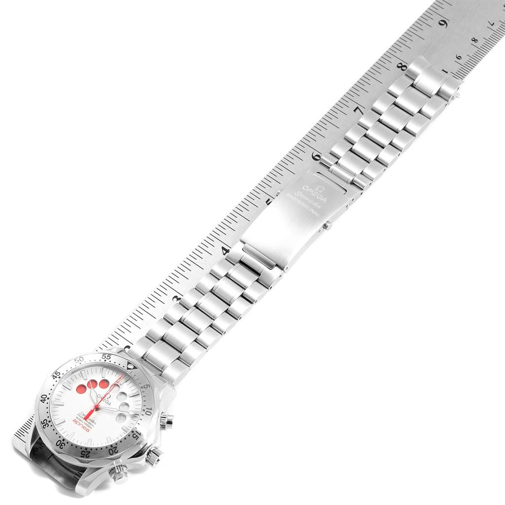 The image shows an Omega Seamaster 2595.30.00 Men
s Stainless Steel Silver Dial 2595.30.00 Men
s Stainless Steel Silver Dial watch laid out flat with a ruler beside it, displaying its bracelet and face.