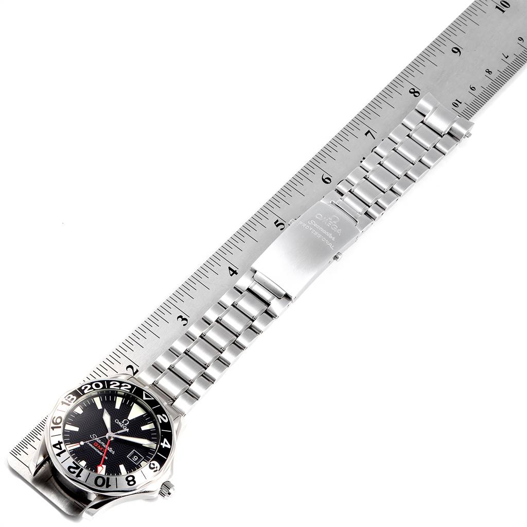 The image displays an Omega Seamaster 2536.50.00 Men's Stainless Steel Black Dial 2536.50.00 Men's Stainless Steel Black Dial watch from a top-down angle, showcasing the dial, bezel, and bracelet against a ruler.