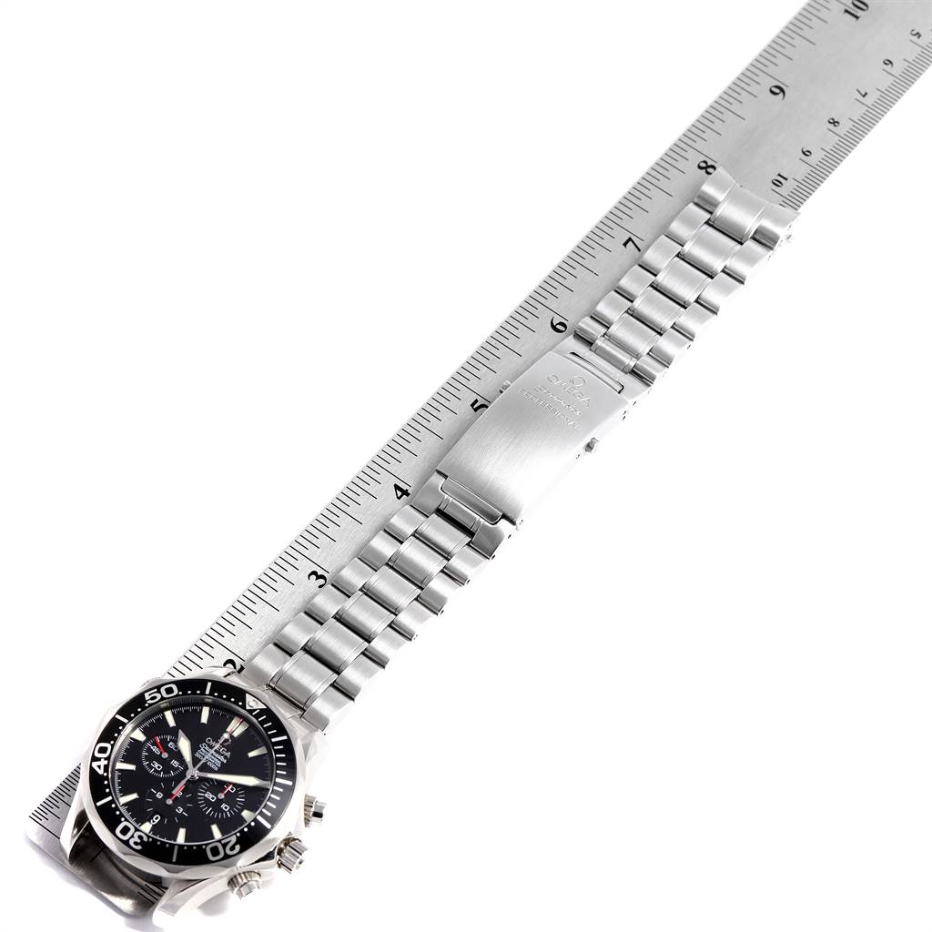 This image shows an Omega Seamaster 2594.52.00 Men
s Stainless Steel Black Dial 2594.52.00 Men
s Stainless Steel Black Dial watch laid flat on a ruler, displaying its face and metal bracelet.