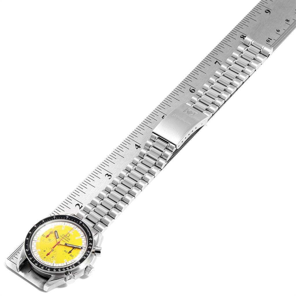 The Omega Speedmaster 3510.12.00 Men's Stainless Steel Yellow Dial 3510.12.00 Men's Stainless Steel Yellow Dial watch is shown from a top-down angle, displaying the face, casing, and metal bracelet with a clasp.
