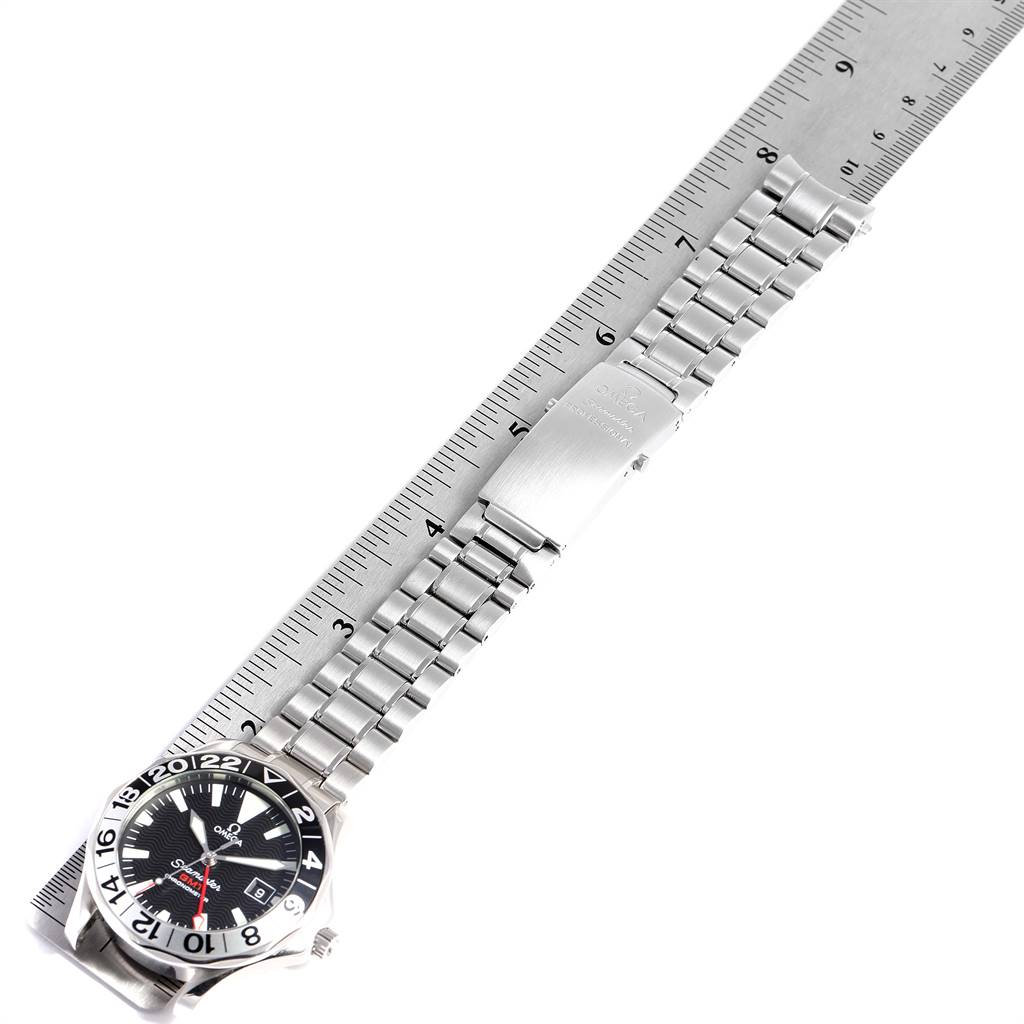 The image shows the Omega Seamaster 2536.50.00 Men
s Stainless Steel Black Dial 2536.50.00 Men
s Stainless Steel Black Dial watch laid flat with its stainless steel bracelet aligned with a ruler.