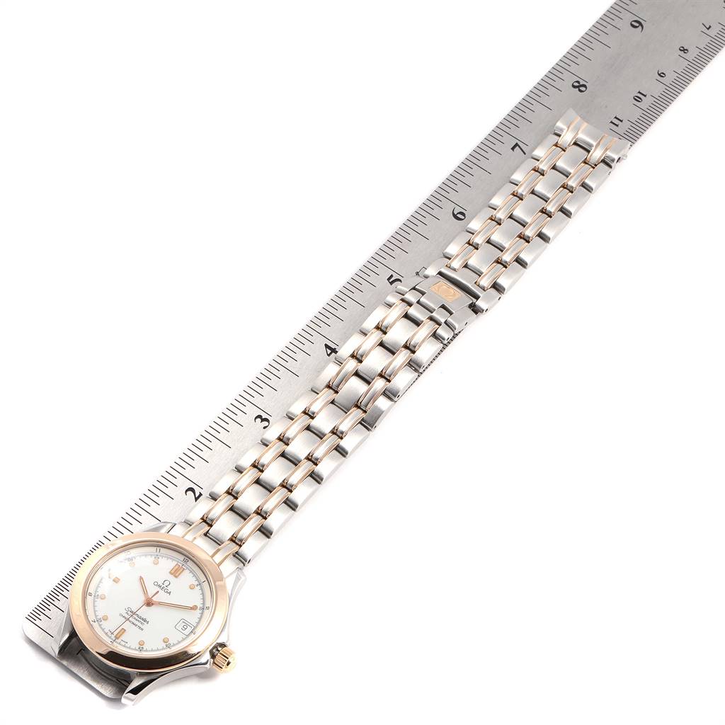 This image shows the Omega Seamaster 168.1501 Men's Steel and Gold (two tone) White Dial 168.1501 Men's Steel and Gold (two tone) White Dial watch lying flat next to a ruler, highlighting the watch's face, bezel, and bracelet.