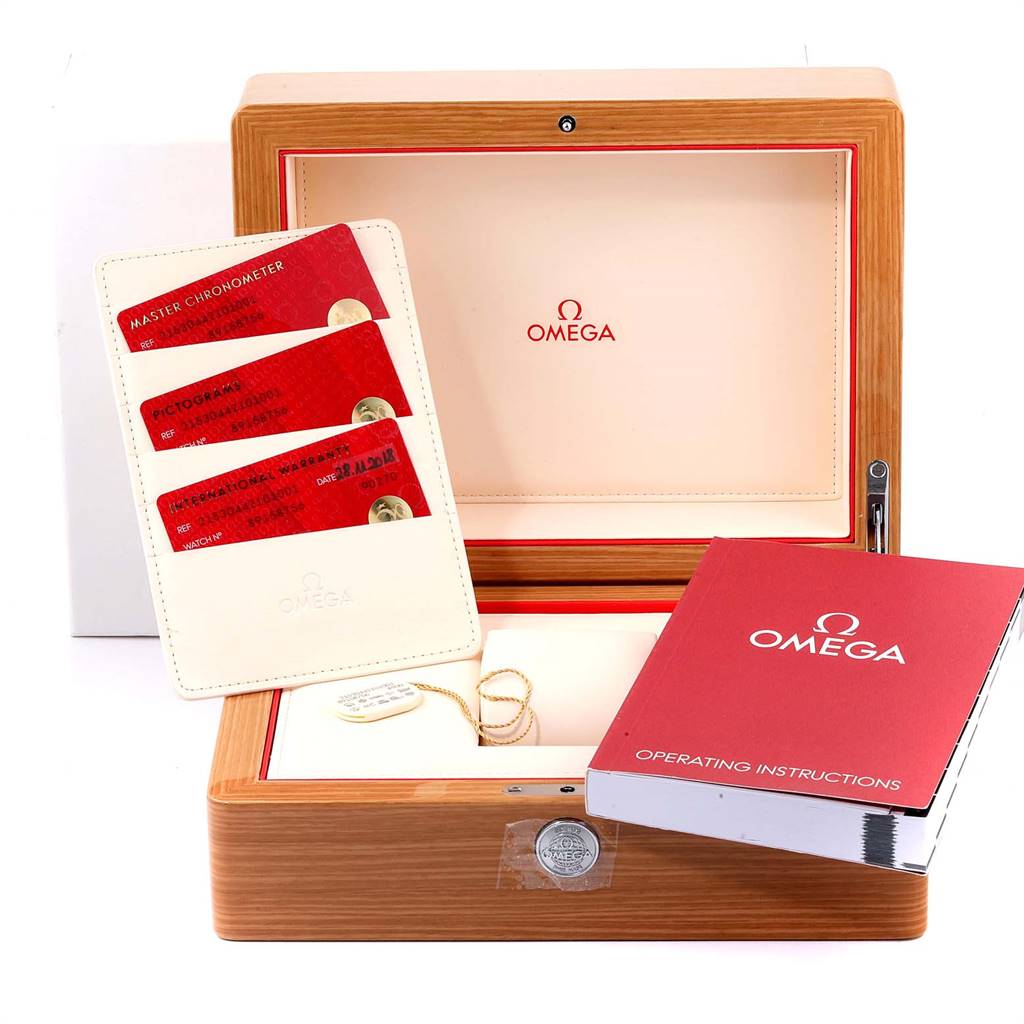 The image shows the packaging, warranty cards, and operating instructions for the Omega Planet Ocean 215.30.44.21.01.001 Men
s Stainless Steel Black Dial 215.30.44.21.01.001 Men
s Stainless Steel Black Dial model.