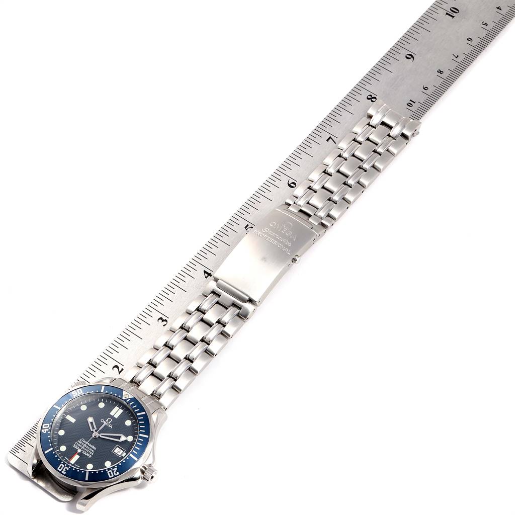 The image shows an Omega Seamaster 2531.80.00 Men
s Stainless Steel Blue Dial 2531.80.00 Men
s Stainless Steel Blue Dial watch laid alongside a ruler, displaying its face, bracelet, and clasp.