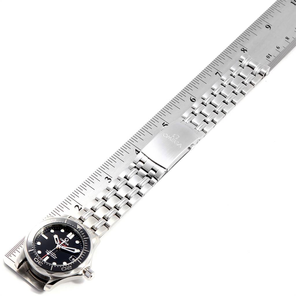 The image shows an Omega Seamaster 212.30.36.20.01.002 Men
s Stainless Steel Black Dial 212.30.36.20.01.002 Men
s Stainless Steel Black Dial watch, laid flat next to a ruler, highlighting its face, bezel, and metal bracelet.