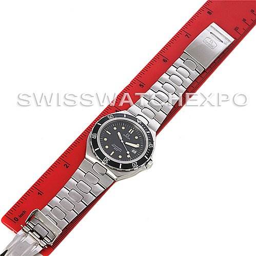 The Omega Seamaster 2810.50.00 Men
s Stainless Steel  2810.50.00 Men
s Stainless Steel  watch is displayed flat with its stainless steel bracelet fully extended alongside a red ruler for measurement.