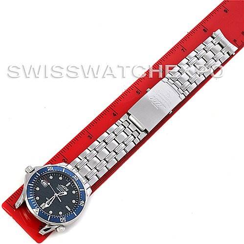 The image shows an Omega Seamaster 0759/10007 Stainless Steel Blue Dial 0759/10007 Stainless Steel Blue Dial watch placed diagonally on a red ruler, displaying the dial and bracelet.