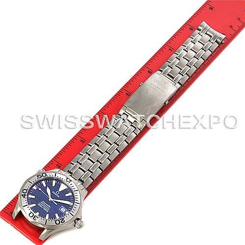 This image shows an overhead view of an Omega Seamaster 2232.80.00 Men's Titanium Blue Dial 2232.80.00 Men's Titanium Blue Dial watch, highlighting the bracelet and clasp, placed next to a red ruler.