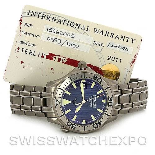 The image shows the Omega Seamaster 2232.80.00 Men's Titanium Blue Dial 2232.80.00 Men's Titanium Blue Dial watch with a metal bracelet and an international warranty card, viewed from a slightly angled perspective.