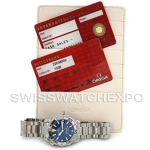 This image shows an Omega Seamaster 2263.80.00 Men's Stainless Steel Blue Dial 2263.80.00 Men's Stainless Steel Blue Dial watch with its original warranty cards and a beige cardholder.