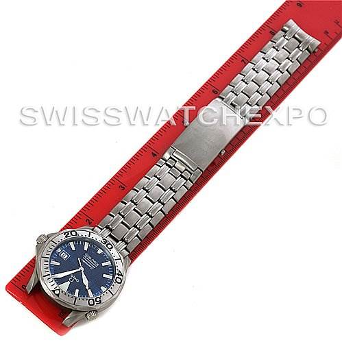 The Omega Seamaster 2231.80.00 Men
s Stainless Steel Blue Dial 2231.80.00 Men
s Stainless Steel Blue Dial watch is shown in full length, with a focus on the stainless steel bracelet and blue dial, placed next to a red ruler.