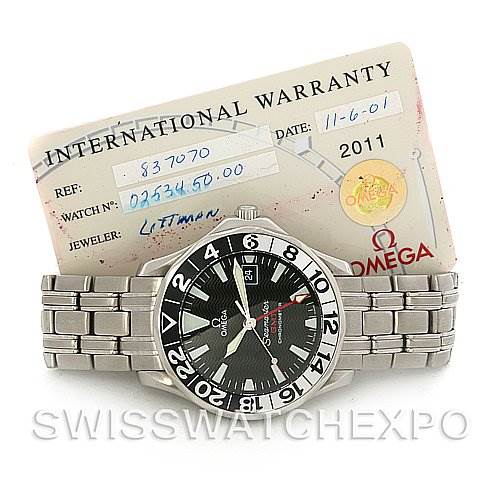 The image shows an Omega Seamaster 2534.50 Men
s Stainless Steel Black Dial 2534.50 Men
s Stainless Steel Black Dial watch from the front angle along with its international warranty card.