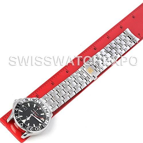 The image shows an Omega Seamaster 2534.50 Men
s Stainless Steel Black Dial 2534.50 Men
s Stainless Steel Black Dial watch laid flat alongside a red ruler, displaying its face and metal bracelet.