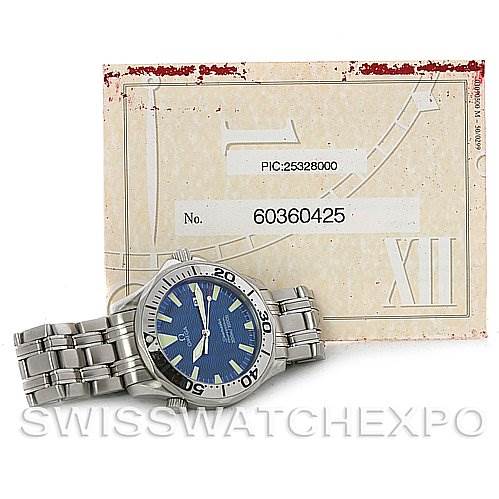 The image shows an Omega Seamaster 2065.80 Men
s Stainless Steel Blue Dial 2065.80 Men
s Stainless Steel Blue Dial watch displayed at an angle, featuring its blue dial, bezel, and stainless steel bracelet, alongside identification paperwork.