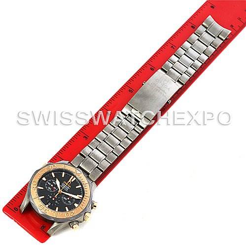 The image shows an Omega Seamaster 2294.50.00 Men's Titanium Black Dial 2294.50.00 Men's Titanium Black Dial watch placed flat next to a red ruler, displaying its face, bezel, crown, and metal bracelet.