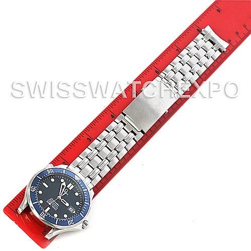 The image shows an Omega Seamaster 2531.80 Men
s Stainless Steel Blue Dial 2531.80 Men
s Stainless Steel Blue Dial watch laid flat with its metal bracelet extended on a red ruler.