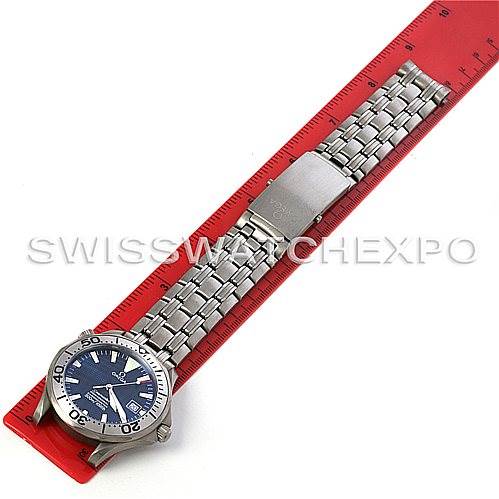 The image shows a top-down view of an Omega Seamaster 2232.80.00 Men
s Titanium Blue Dial 2232.80.00 Men
s Titanium Blue Dial watch placed beside a red ruler.