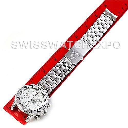 The image shows the Omega Seamaster 2598.20.00 Men's Stainless Steel White Dial 2598.20.00 Men's Stainless Steel White Dial watch from a top-down angle, featuring the face, bezel, and metal bracelet against a red ruler.