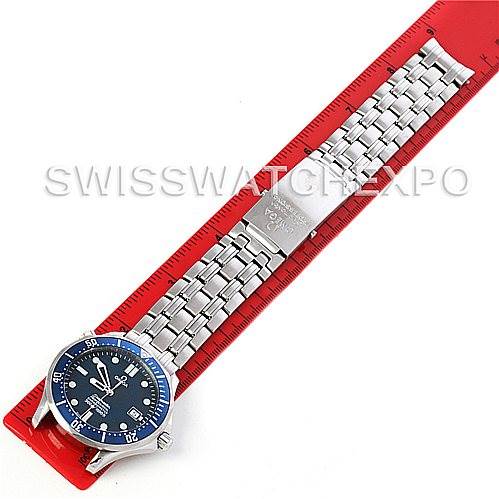 The image shows an overhead view of an Omega Seamaster 2531.80.00 Men
s Stainless Steel Blue Dial 2531.80.00 Men
s Stainless Steel Blue Dial watch with its stainless steel bracelet extended on a red ruler.