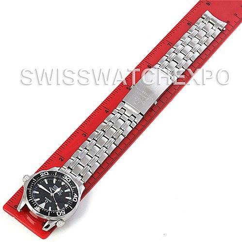 The image shows an Omega Seamaster 212.30.36.20.01.001 Women's Stainless Steel Black Dial 212.30.36.20.01.001 Women's Stainless Steel Black Dial watch laid flat, featuring its face and stainless steel bracelet next to a red ruler.