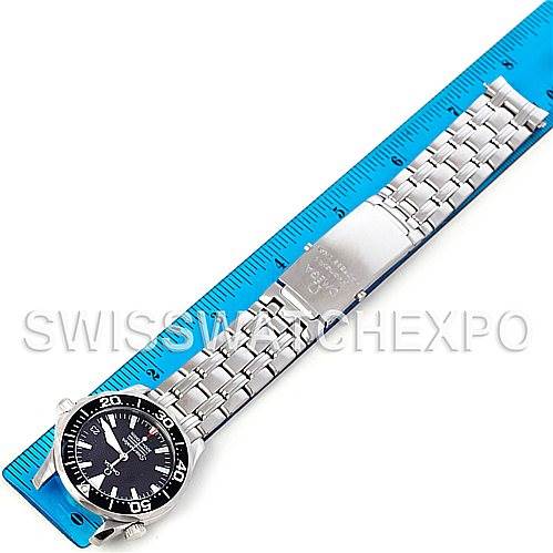 The Omega Seamaster 2252.50.00 Men's Stainless Steel Black Dial 2252.50.00 Men's Stainless Steel Black Dial watch is shown from a top-down angle, displaying the full bracelet and face, placed on a blue ruler.