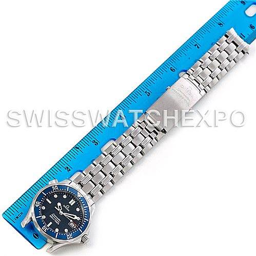 The image shows an Omega Seamaster 2223.80.00 Men
s Stainless Steel Blue Dial 2223.80.00 Men
s Stainless Steel Blue Dial watch laid flat beside a blue ruler, displaying its face, bezel, and metal bracelet.