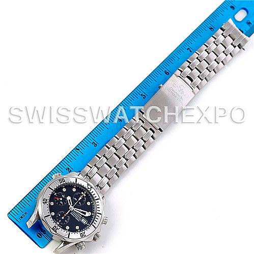 The image shows an Omega Seamaster 2598.80.00 Men's Stainless Steel Blue Dial 2598.80.00 Men's Stainless Steel Blue Dial watch, laid flat next to a blue ruler, displaying its full length including the bracelet and face.