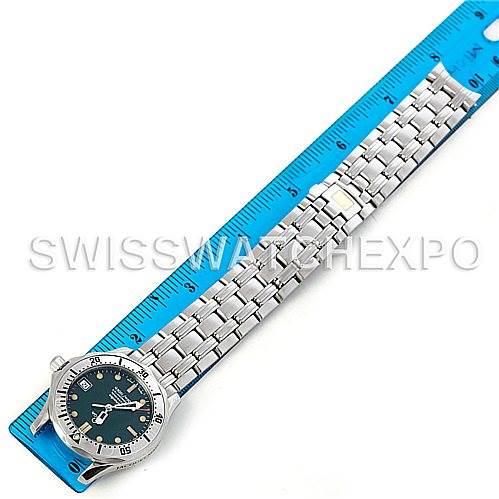 The Omega Seamaster 2553.41.00 Men's Stainless Steel Green Dial 2553.41.00 Men's Stainless Steel Green Dial watch is shown from a top-down angle, displaying the face, bezel, and entire bracelet alongside a ruler for scale.