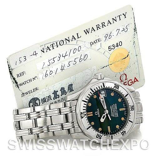The image shows an Omega Seamaster 2553.41.00 Men's Stainless Steel Green Dial 2553.41.00 Men's Stainless Steel Green Dial watch at a slight angle, displaying the face and part of the bracelet, positioned in front of a warranty card.