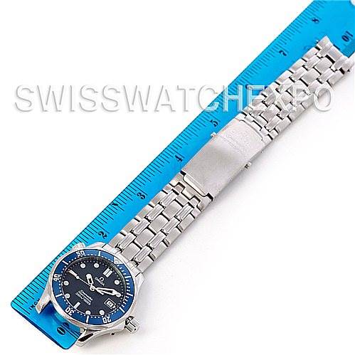 The image shows a top-down view of an Omega Seamaster 2223.80.00 Men
s Stainless Steel Blue Dial 2223.80.00 Men
s Stainless Steel Blue Dial watch with a blue dial and stainless steel bracelet, placed beside a ruler.