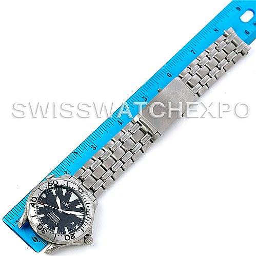 The Omega Seamaster 2031.50.00 Men's Titanium Black Dial 2031.50.00 Men's Titanium Black Dial watch is shown from an overhead angle with its stainless steel bracelet next to a blue ruler for scale.