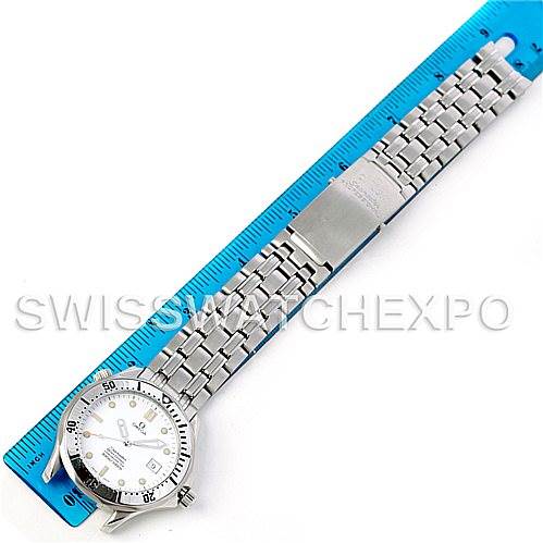 The Omega Seamaster Men
s Stainless Steel White Dial Men
s Stainless Steel White Dial watch is shown from above, displaying the face, bezel, bracelet, and clasp next to a blue ruler for scale.