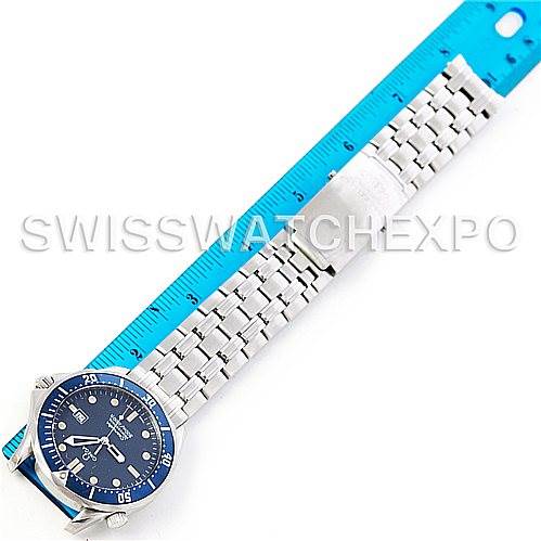 The image shows a top-down view of an Omega Seamaster 2541.80.00 Men's Stainless Steel Blue Dial 2541.80.00 Men's Stainless Steel Blue Dial watch with a blue dial and silver metal bracelet next to a blue ruler.