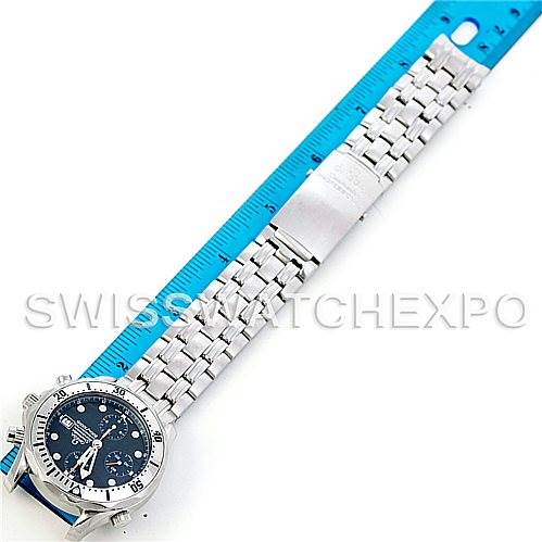 The image shows an Omega Seamaster 2598.80.00 Men
s Stainless Steel Blue Dial 2598.80.00 Men
s Stainless Steel Blue Dial watch laid flat with its bracelet extended and positioned beside a blue ruler for scale.