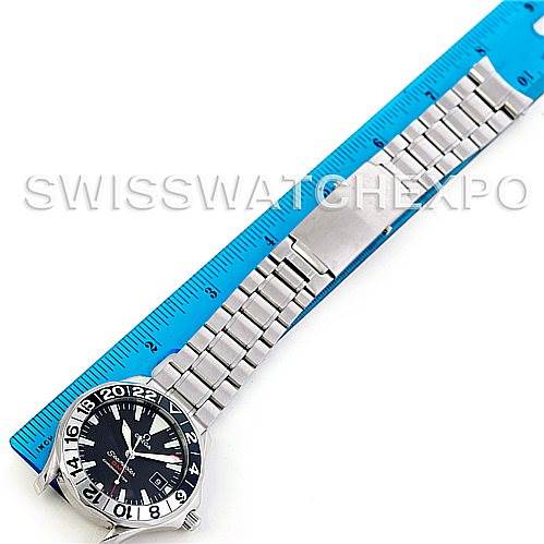 The image shows an Omega Seamaster 2234.50.00 Men
s Stainless Steel Black Dial 2234.50.00 Men
s Stainless Steel Black Dial watch laid flat, with its bracelet aligned with a blue ruler for measurement.