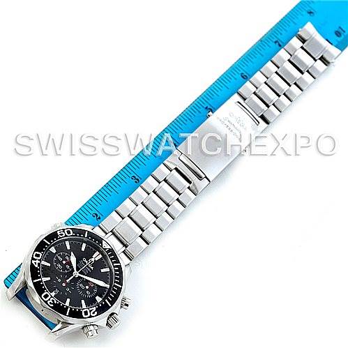 The image shows an Omega Seamaster 2594.52.00 Men's Stainless Steel Black Dial 2594.52.00 Men's Stainless Steel Black Dial watch laid flat alongside a blue measuring ruler, displaying the face, bezel, bracelet, and clasp.