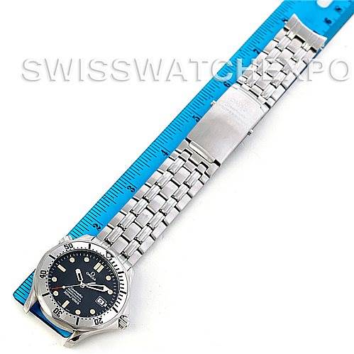 The Omega Seamaster 2532.80.00 Men
s Stainless Steel Grey Dial 2532.80.00 Men
s Stainless Steel Grey Dial watch is shown from a top-down angle, highlighting its face and metal bracelet beside a blue ruler.