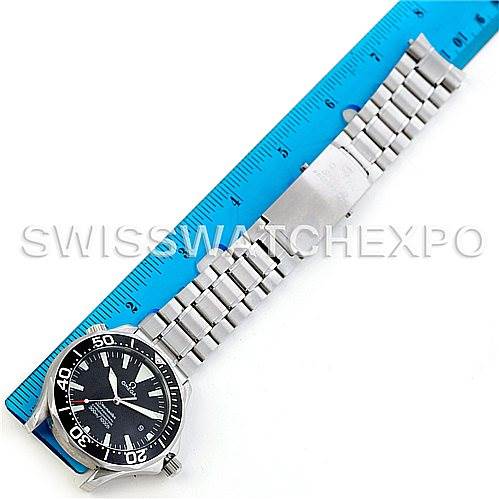 The image shows an Omega Seamaster 2254.50.00 Men
s Stainless Steel Black Dial 2254.50.00 Men
s Stainless Steel Black Dial watch at a diagonal angle, displaying its dial, bezel, and metal bracelet against a blue ruler.