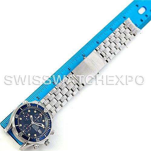 The image shows the Omega Seamaster 2599.80.00 Men
s Stainless Steel Blue Dial 2599.80.00 Men
s Stainless Steel Blue Dial watch from a top-down angle alongside a blue ruler, highlighting its bracelet and face.