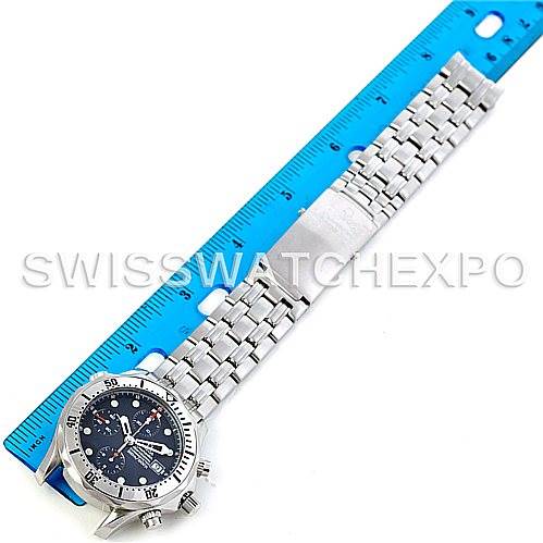 This image shows the Omega Seamaster 2598.80.00 Men
s Stainless Steel Blue Dial 2598.80.00 Men
s Stainless Steel Blue Dial watch laid flat beside a blue ruler, displaying its face, bezel, crown, and stainless steel bracelet.