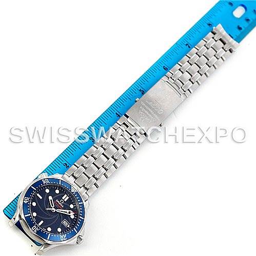 The image shows a top-down view of an Omega Seamaster 2226.80.00 Men
s Stainless Steel Blue Dial 2226.80.00 Men
s Stainless Steel Blue Dial watch with its bracelet laid out next to a blue ruler.