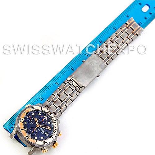 The image shows an Omega Seamaster 2296.80.00 Men
s Titanium Blue Dial 2296.80.00 Men
s Titanium Blue Dial watch laid flat alongside a blue ruler, highlighting the full bracelet and the face.