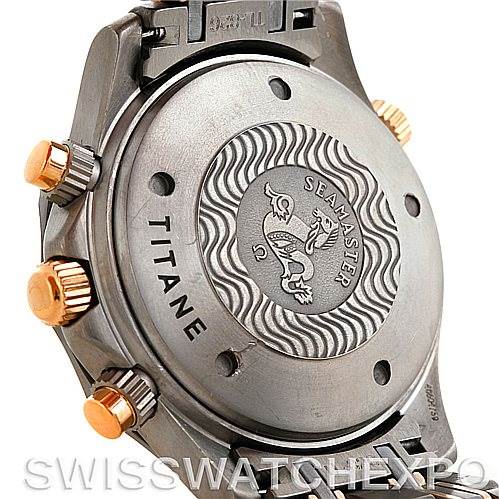 The image shows the back case and pushers of an Omega Seamaster 2296.80.00 Men
s Titanium Blue Dial 2296.80.00 Men
s Titanium Blue Dial watch with a titanium finish and engraved logo.