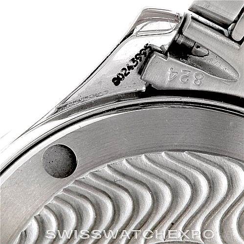 The image shows the Omega Seamaster 2252.50.00 Men
s Stainless Steel Black Dial 2252.50.00 Men
s Stainless Steel Black Dial watch
s case back and part of the bracelet attachment, viewed at a close-up angle.