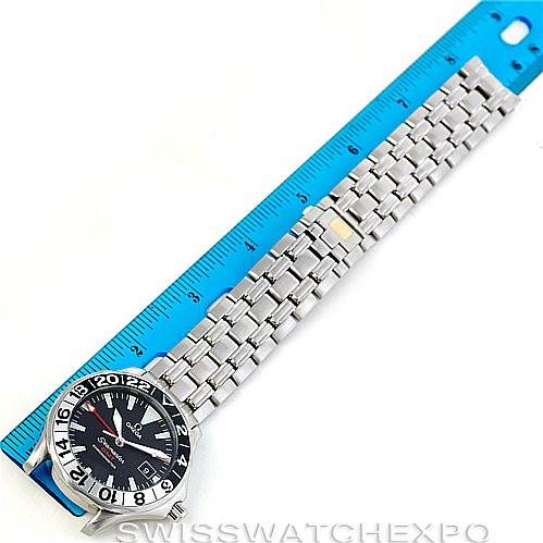 The image shows an Omega Seamaster 2234.50.00 Men
s Stainless Steel Black Dial 2234.50.00 Men
s Stainless Steel Black Dial watch from a top-down perspective, displaying the bracelet and face aligned with a blue ruler.