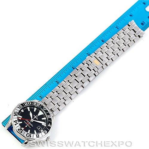 The image shows an Omega Seamaster 2234.50.00 Men
s Stainless Steel Black Dial 2234.50.00 Men
s Stainless Steel Black Dial watch laid flat with its dial and stainless steel bracelet visible, next to a ruler.